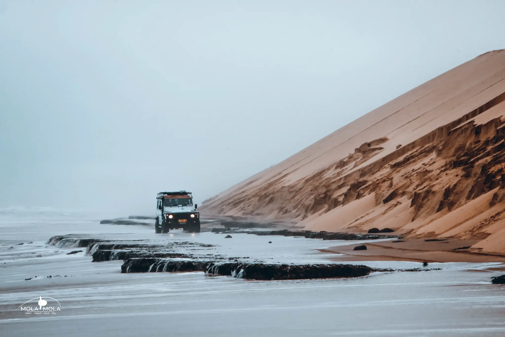 4x4 crossing rocky shore at Sandwich Harbour