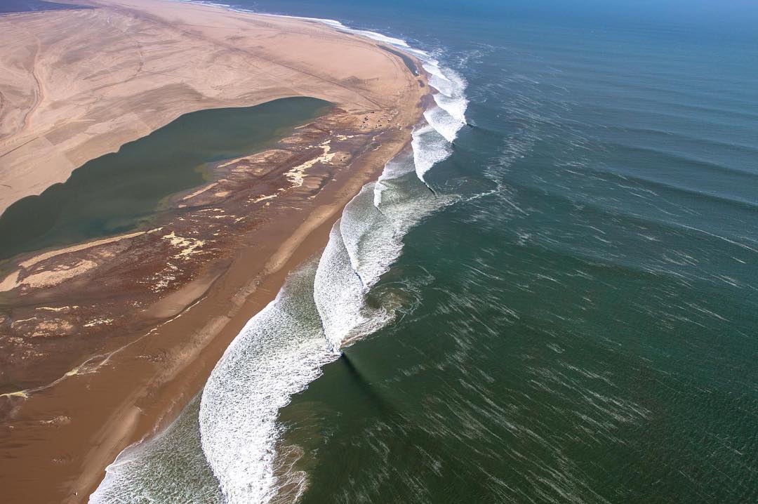 Aerial view of Skeleton Bay wave breaking along the Namibian coast